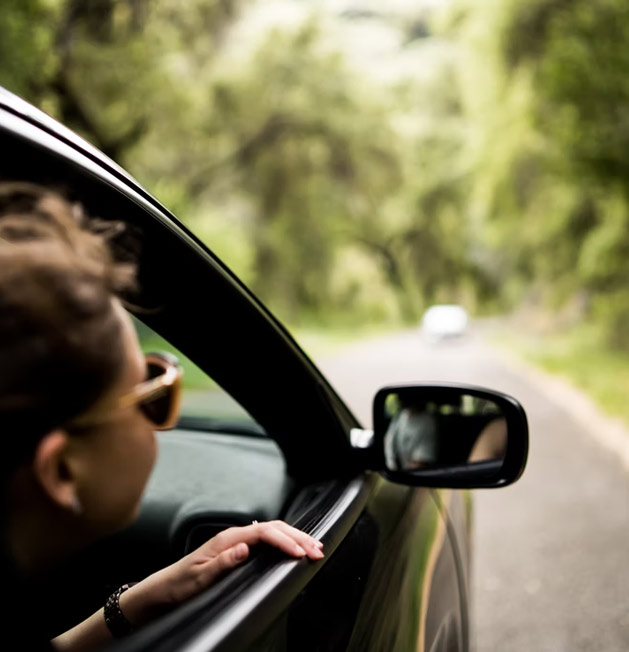 Young girl looking out car window